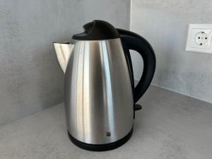 a silver and black kettle sitting on a counter at Lindenberg Apartments in Wernigerode