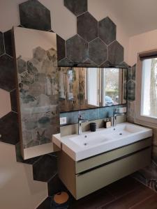 a bathroom with a sink and a mirror at Le Lodge du Parc in Beaune +39 photos