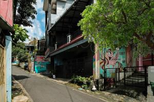 a street with graffiti on the side of a building at OYO Life 92258 Kostel 21 Syariah in Semarang