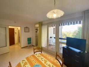 a bedroom with a bed and a view of a balcony at Studio Les Bastides in Gréoux-les-Bains