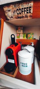 a shelf with a coffee maker and cups on it at Nuit insolite à bord d'un voilier et sortie à la Voile au cœur de la ville de Sète in Sète