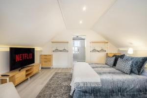 a bedroom with a bed and a flat screen tv at Douro Prestige Urban Retreat with shared S-Pool & Gym in Porto +71 photos