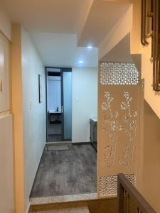 a hallway with a door with a painting on it at Chill Home 1 in Ho Chi Minh City
