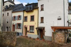 a group of white buildings in a city at Ferienhaus Saar-Traum in Saarburg