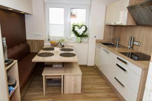 a small kitchen with a table and a sink at Ferienhaus Saar-Traum in Saarburg