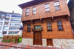 a wooden building with windows and a door at Kum Butik hotel in Amasra