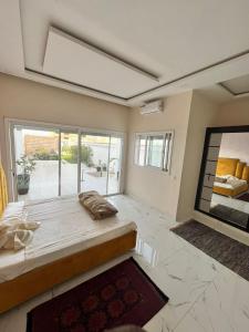a bedroom with a large bed and a large window at Diamond House in Saly Portudal