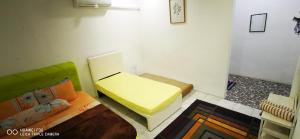 a room with a bed and a couch in it at NJ_Homestay@KKIA/Petagas KK in Kota Kinabalu
