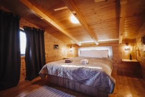 a bedroom with a bed in a wooden cabin at Holiday Home Nightswim Inn in Vrbovec