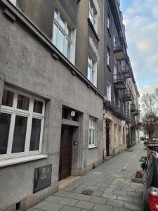 an empty street in front of a building at Riverside Kazimierz Castle 3 min p4you pl in Krakow