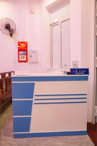 a blue and white counter in a room with a window at Hoa ban Homestay in Hue