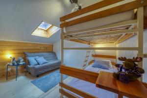 a bedroom with two bunk beds and a couch at Chalet View on Vanoise Mountain - 2 bedrooms 70m2 in Cevins
