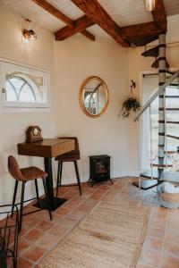 a living room with a table and a fireplace at Landgoed Halsaf in Babberich