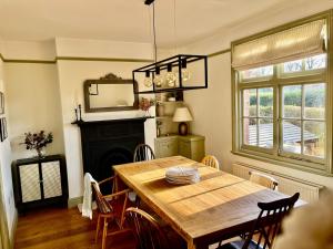 a dining room with a table and a fireplace at Central Knutsford in Knutsford