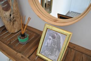 a framed picture on a table in front of a mirror at Maison Sidi et Lalla in Essaouira