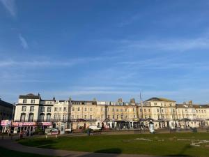 a large building with a park in front of it at Spacious apartment with Sea Views on Great Yarmouth Seafront in Great Yarmouth