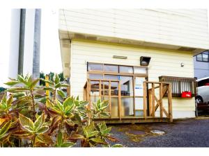 a small house with glass doors on the side of it at Guest House Momiji Nikko - Vacation STAY 13409 in Nikko