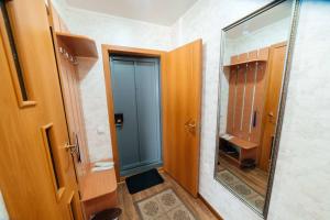 a bathroom with a blue door and a mirror at Светлая и уютная в центре in Pavlodar