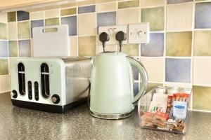 a kitchen counter with a toaster and a coffee maker at Modern 4-Level Townhouse for 8 Free Parking Bournemouth in Bournemouth