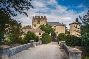 a large castle with a road in front of it at Bastide la Fondue in Allemagne-en-Provence