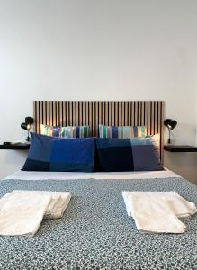 a bedroom with a bed with two towels on it at Cascina Bellaria in Milan