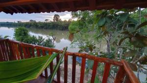 a hammock on a deck with a view of a river at Floor river view in Cat Tien