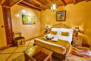 a bedroom with a large bed in a room at Riad Mimouna in Essaouira