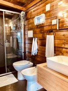 a bathroom with a toilet and a sink at Glamping&BeerSpa Scialla Sul Lago in Pignola