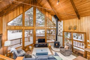 a large living room with wooden walls and large windows at Kelly's Chalet in Girdwood