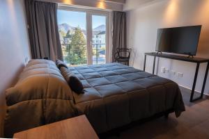 Portales de la Patagonia Apartments客房内的一张或多张床位