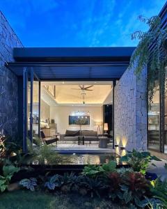 a living room with a couch and a table at K House Phan Thiet by Blue Fingers in Ấp Bình Hưng