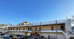 a building with motorcycles parked in a parking lot at Hari Om Residency in Bhuj