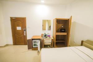 a room with a bed and a table and a door at Casino Hotels Ltd in Trichūr