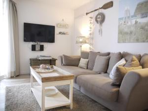 a living room with a couch and a table at Strandperle 5 in Scharbeutz