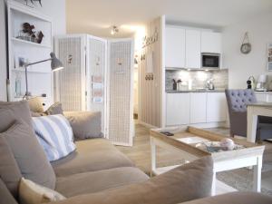 a living room with a couch and a table at Strandperle 5 in Scharbeutz