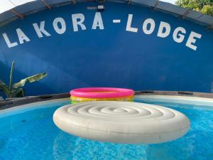 two frisbees are sitting in a swimming pool at La kora in Toubakouta