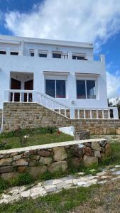 a white house sitting on top of a stone wall at Casa Amanecer Zemzem / Marina Smir in Marina Smir