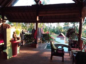 a patio with a chair and a swimming pool at Villa Pintu Bintang in Pawenang