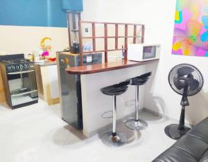 a toy kitchen with a counter and stools at Apartamento - Centro Histórico 209 San Agustin in Cartagena de Indias