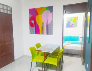 a dining room with a table and chairs and a painting at Apartamento - Centro Histórico 209 San Agustin in Cartagena de Indias
