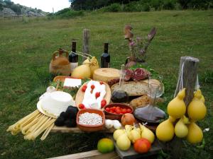 a picnic table with food and wine on a field at Il Pentagono in Termoli