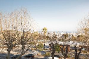 a view of a city with trees and a freeway at Hôtel Le Collier in Antibes