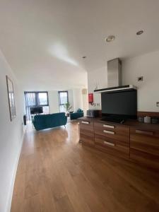 sala de estar amplia con TV de pantalla plana grande en Blonk Street I Quarter Apartment en Sheffield