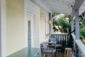 a balcony with chairs and a glass table at A cozy home away from home in Bad Ischl