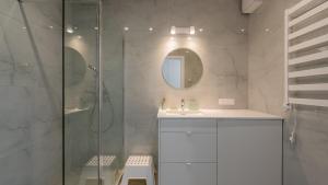 a bathroom with a shower and a sink and a mirror at Sea&Lake, Sun & Snow in Mielno