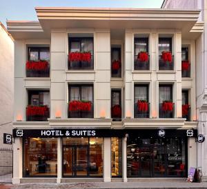 a hotel and suites building with red flowers in windows at KA Hotel & Suites in Istanbul
