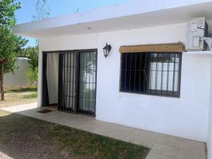 a white building with black barred windows on it at Atlantic 10 in Atlántida