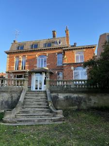 una vieja casa de ladrillo con escaleras delante en Maison de 5 chambres avec piscine privee jardin clos et wifi a Bailleul en Bailleul