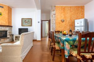 a dining room with a table and a fireplace at Casa splendida in Monreale