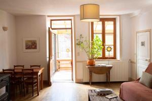 a living room with a table and a dining room at Les Soleils in Mérinchal